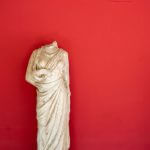 headless statue red background