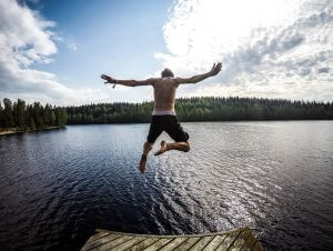 Man jumping into a lake