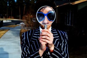 model with a magnifying glass on her face