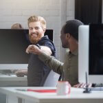 Revolutionize Your Sfcc Experience With Headless Commerce Front Commerce Smiling Bearded Man Giving Fist Bump Male Colleague