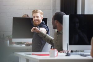 Revolutionize Your Sfcc Experience With Headless Commerce Front Commerce Smiling Bearded Man Giving Fist Bump Male Colleague